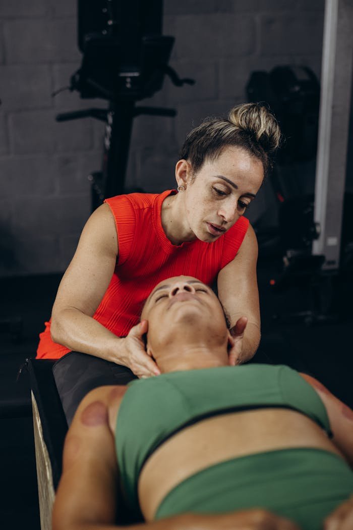 A physical therapist provides manual therapy to a client for rehabilitation and recovery indoors.